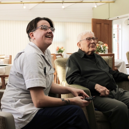 Salveo Care | Image showing our staff and residents watching the TV