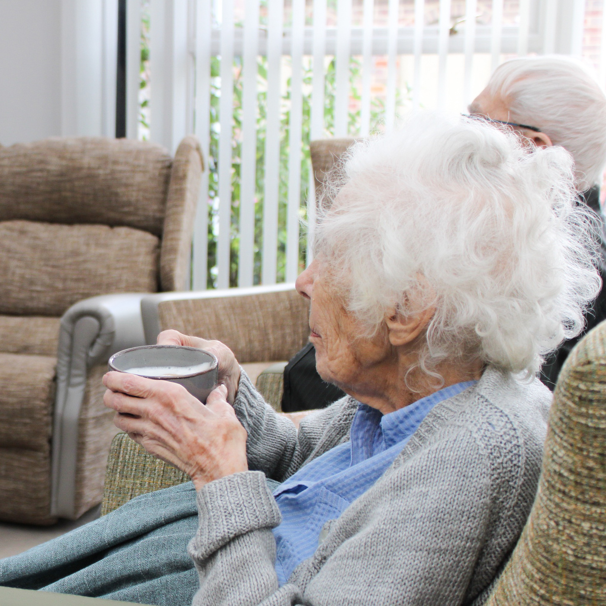 Salveo Care | an image showing two of our residents enjoying the communal lounge