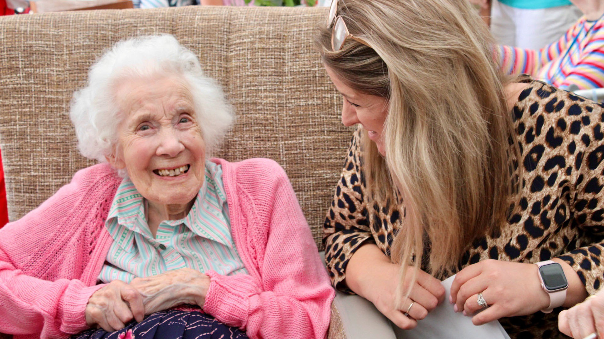 Salveo Care | One of our residents interacting with a member of staff and smiling.